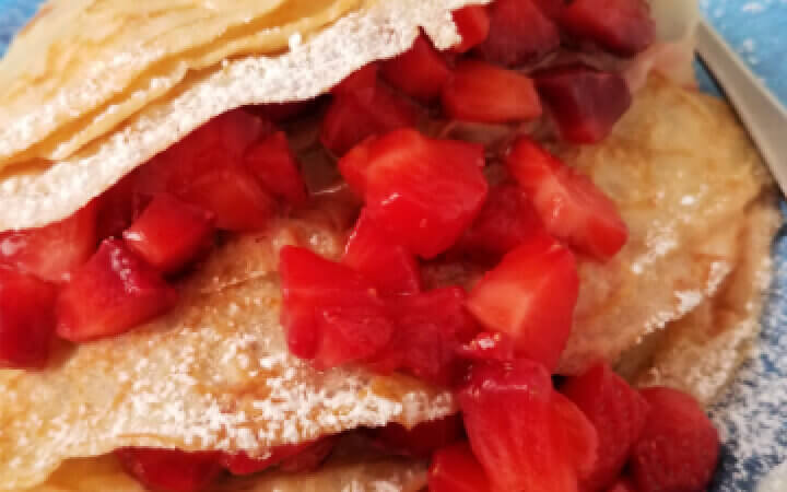 square photo of strawberry and nutella crepes
