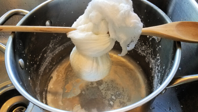 draining excess liquid from the homemade ricotta