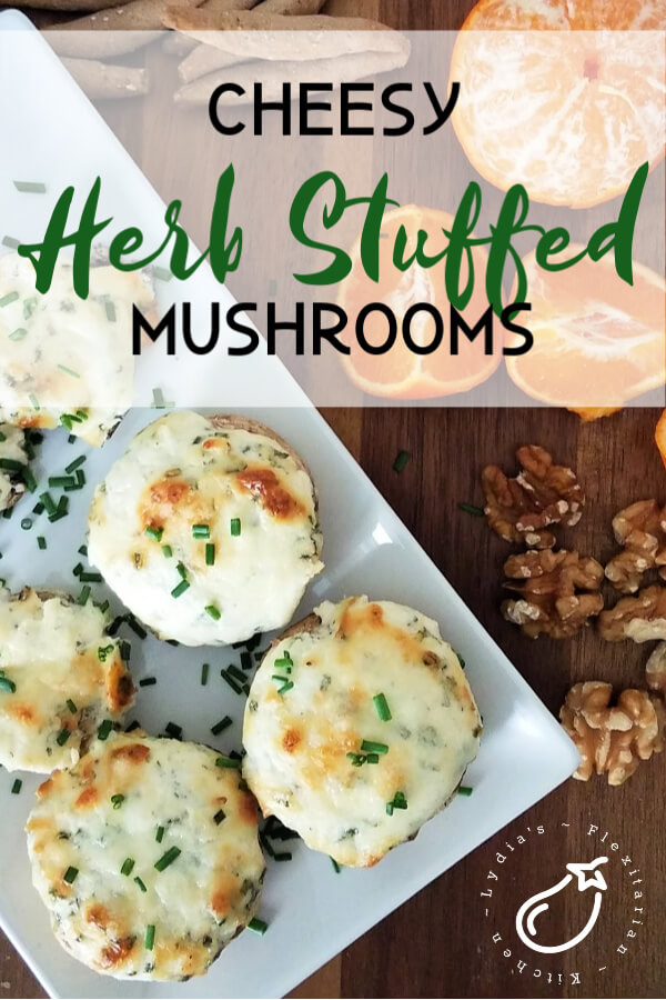 large photo of cheesy herb stuffed mushrooms being served with sliced oranges, walnuts and crackers
