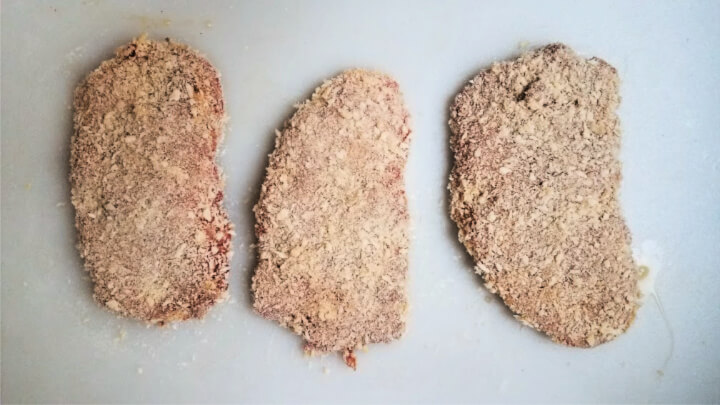 photo of Spanish style chicken fried steaks with breading, ready to fry