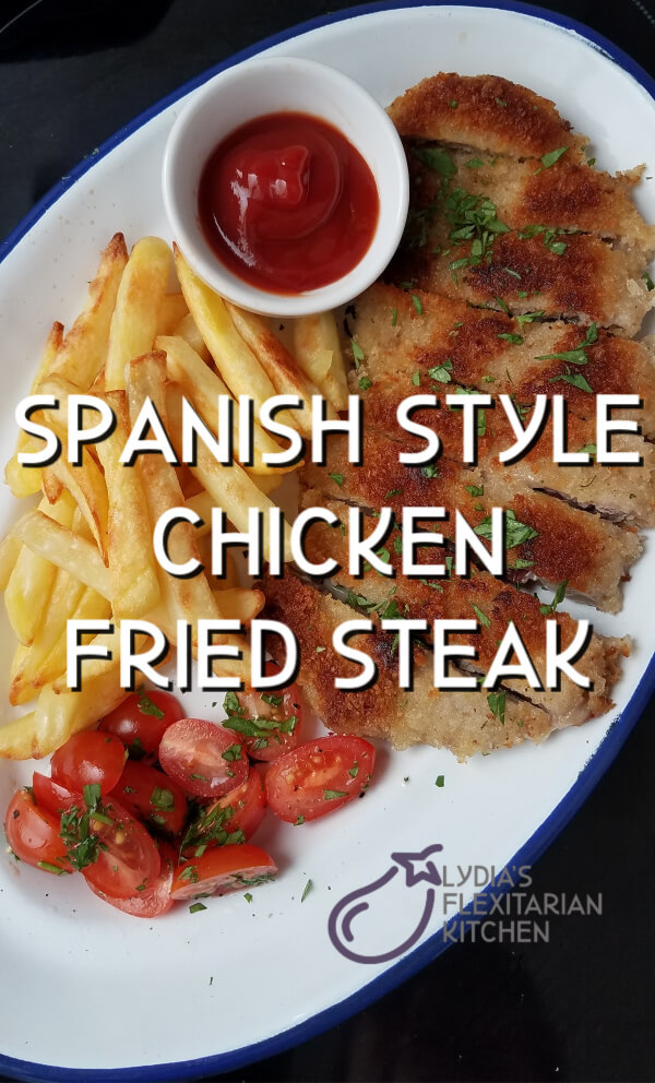 large photo with text of Spanish style chicken fried steak on a platter with tomatoes and fries