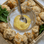 cheesy sausage biscuits in a basket with mustar