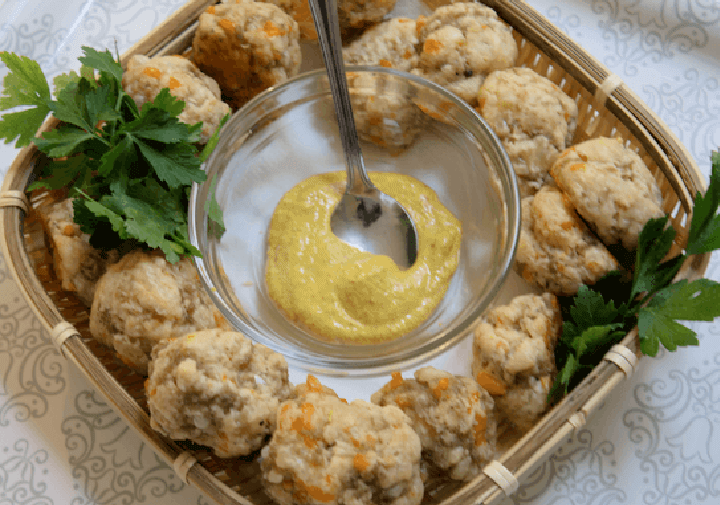 cheesy sausage biscuits in a basket with mustar