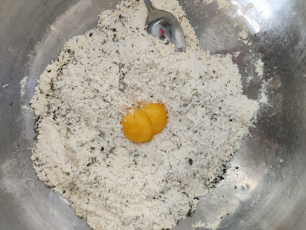 adding egg yolk to pastry mix