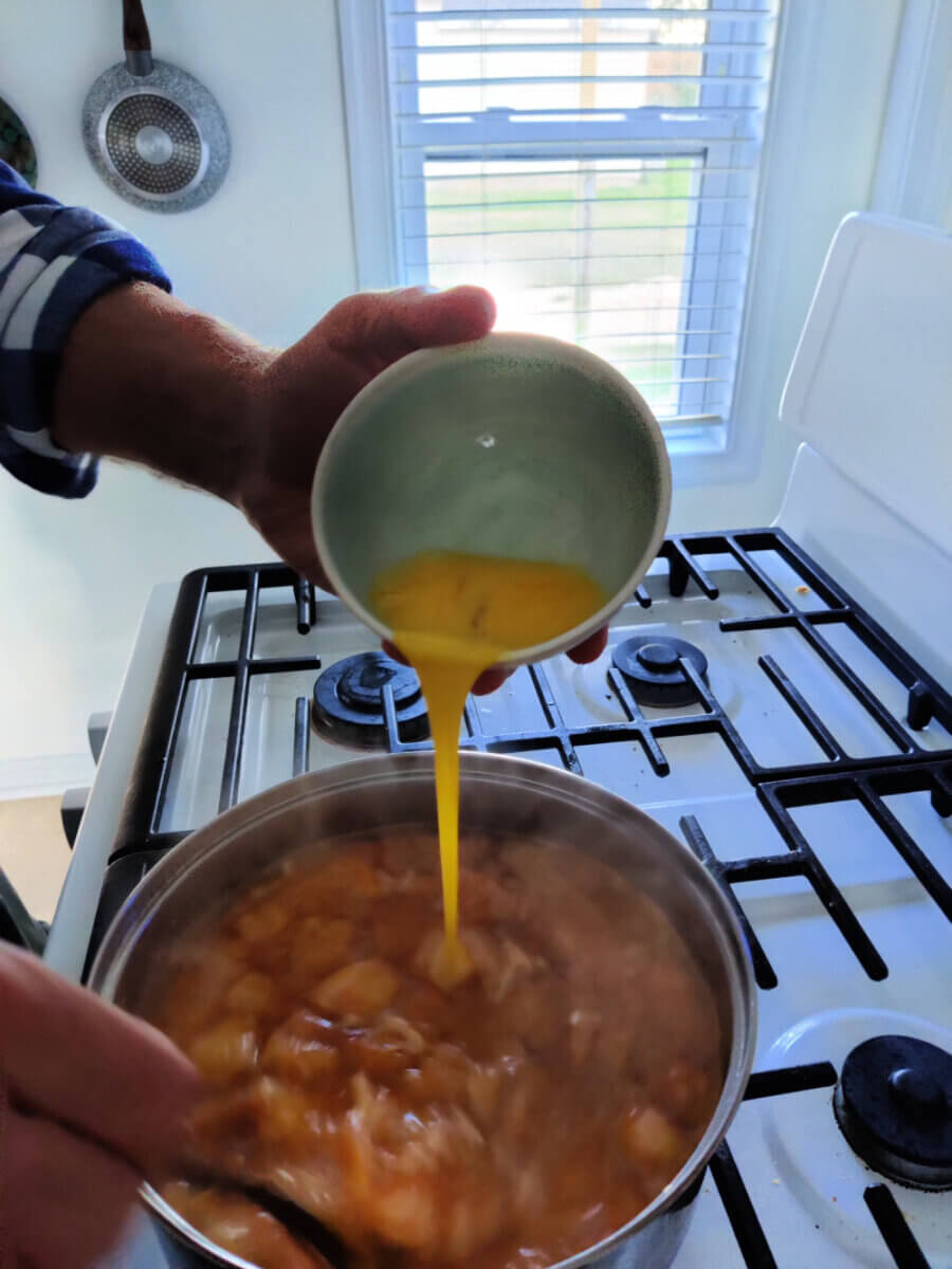 adding egg to garlic soup
